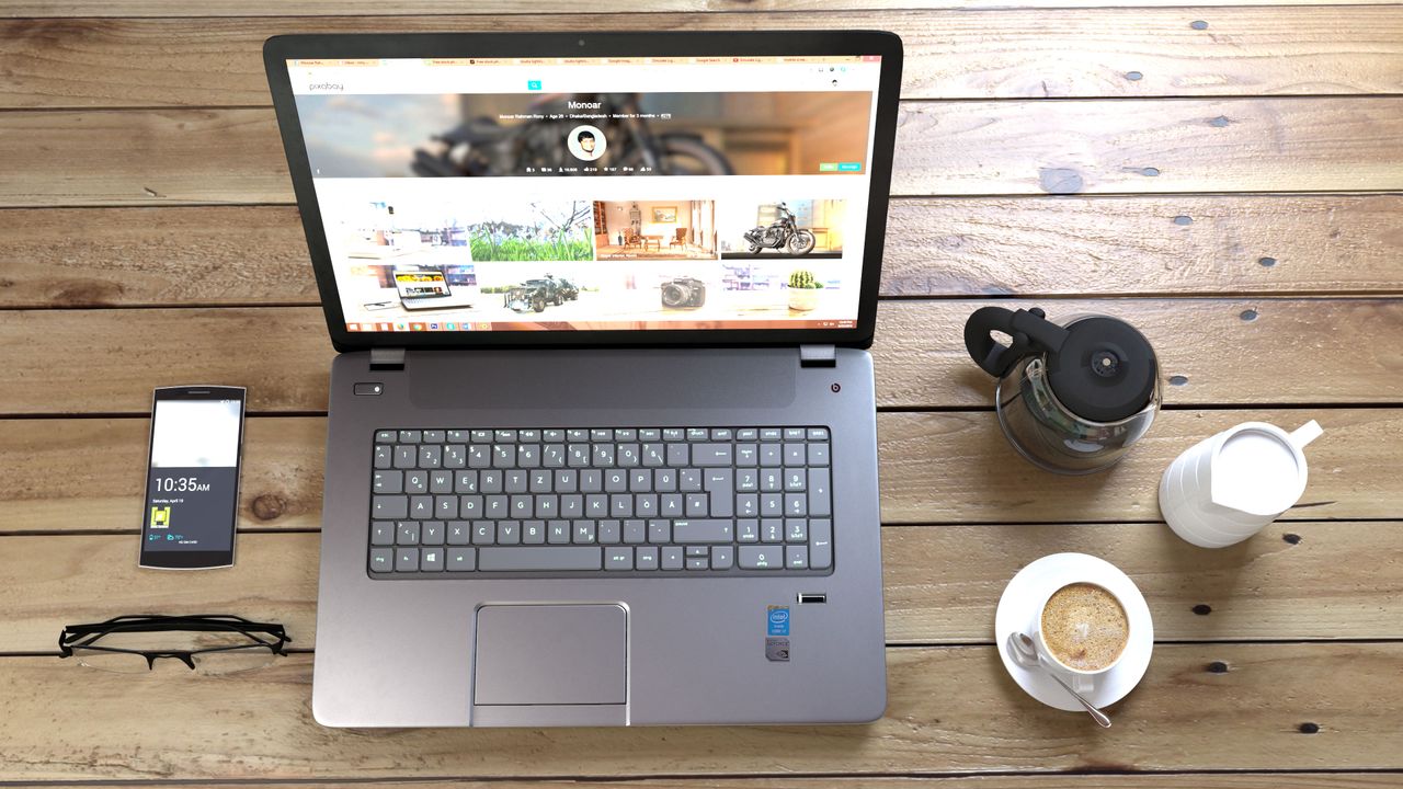 Crafting Captivating Headlines: Your awesome post title goes here Top view of a laptop, smartphone, coffee, and glasses on a wooden desk.