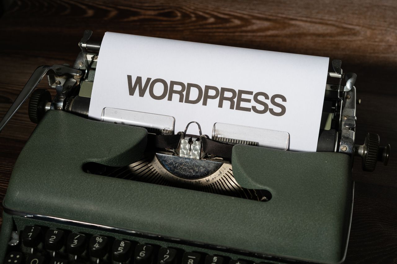 Services Close-up of a vintage typewriter with 'WordPress' typed on white paper.